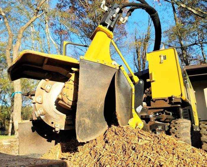 Stump grinder cutting a stump below ground level